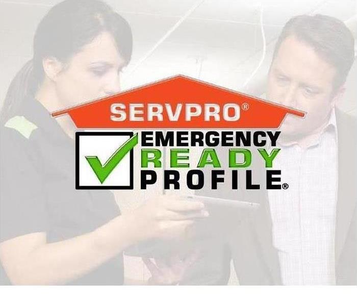 A man and a woman looking a cell phone- says SERVPRO Emergency Ready Profile